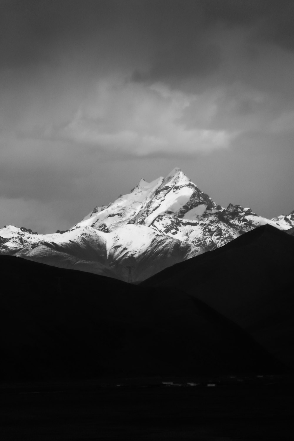 grayscale photo of mountain coated snow