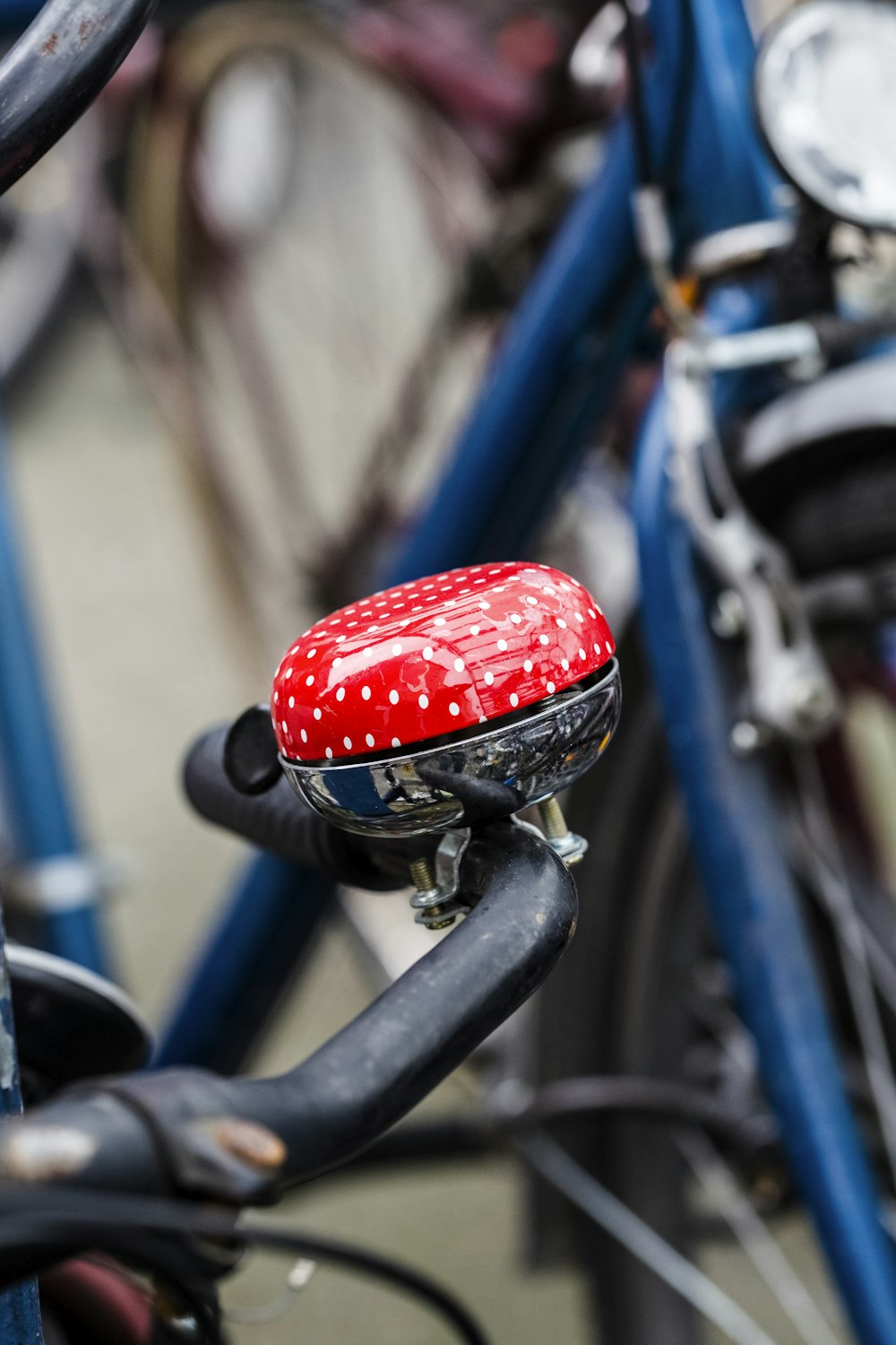 red and blue bicycle bell on black bicycle