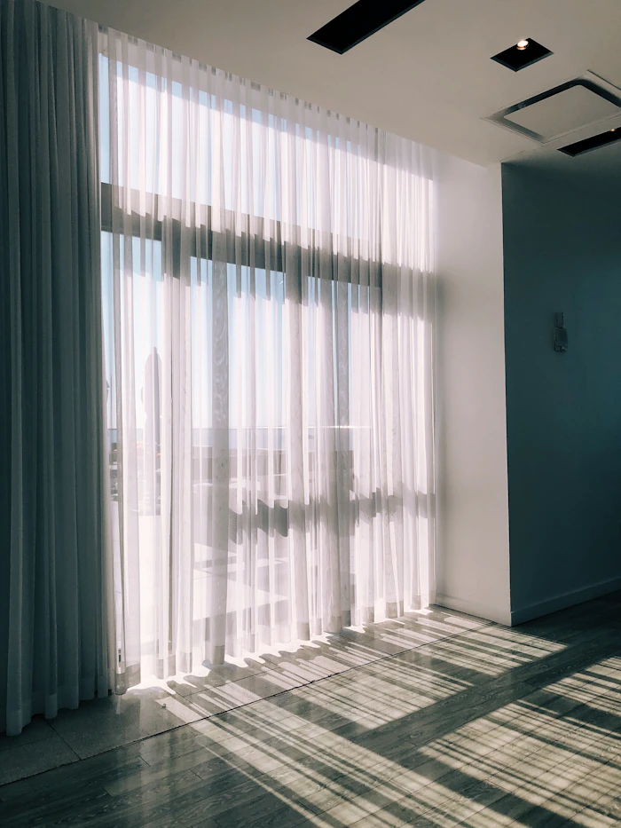Clean white curtains by a window