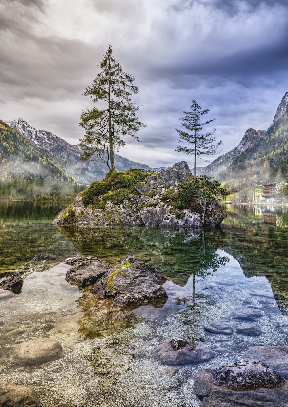 body of water within mountain range during daytime