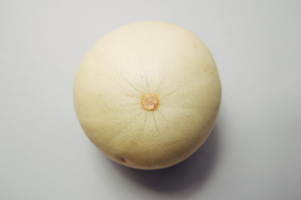 round brown fruit placed on white surface