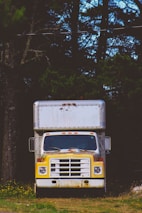 closeup photo of white and yellow box truck