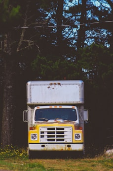 closeup photo of white and yellow box truck