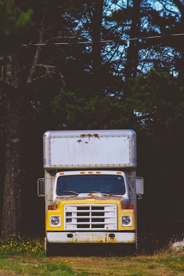 closeup photo of white and yellow box truck