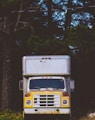 closeup photo of white and yellow box truck