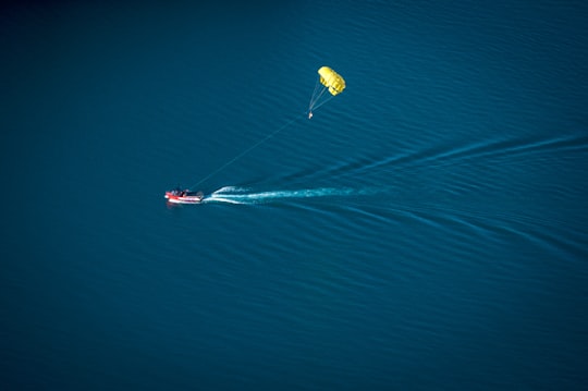 parachute near red personal water craft in Lake Wakatipu New Zealand