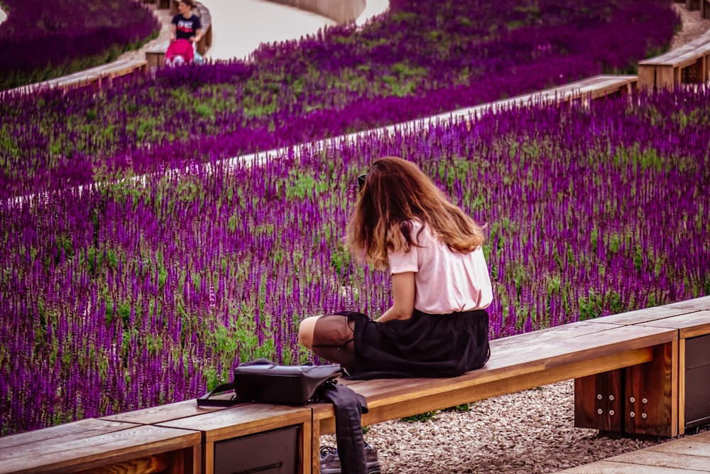 woman sitting on brown wooden bench