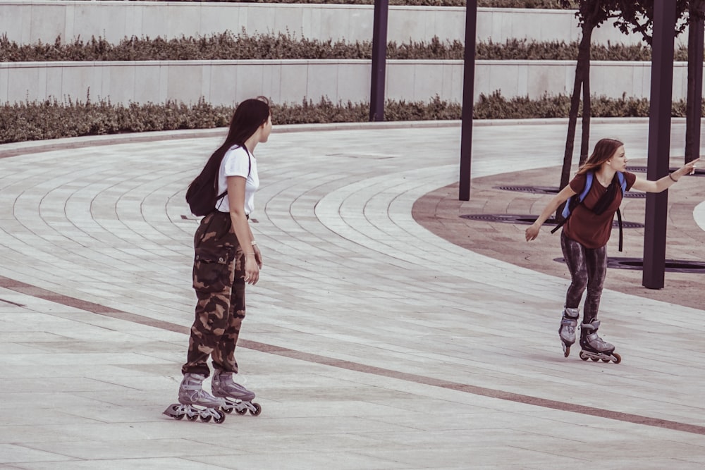 two women inside park while on inline skates