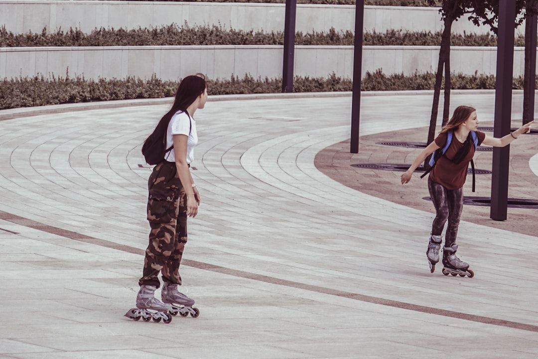 two women inside park while on inline skates