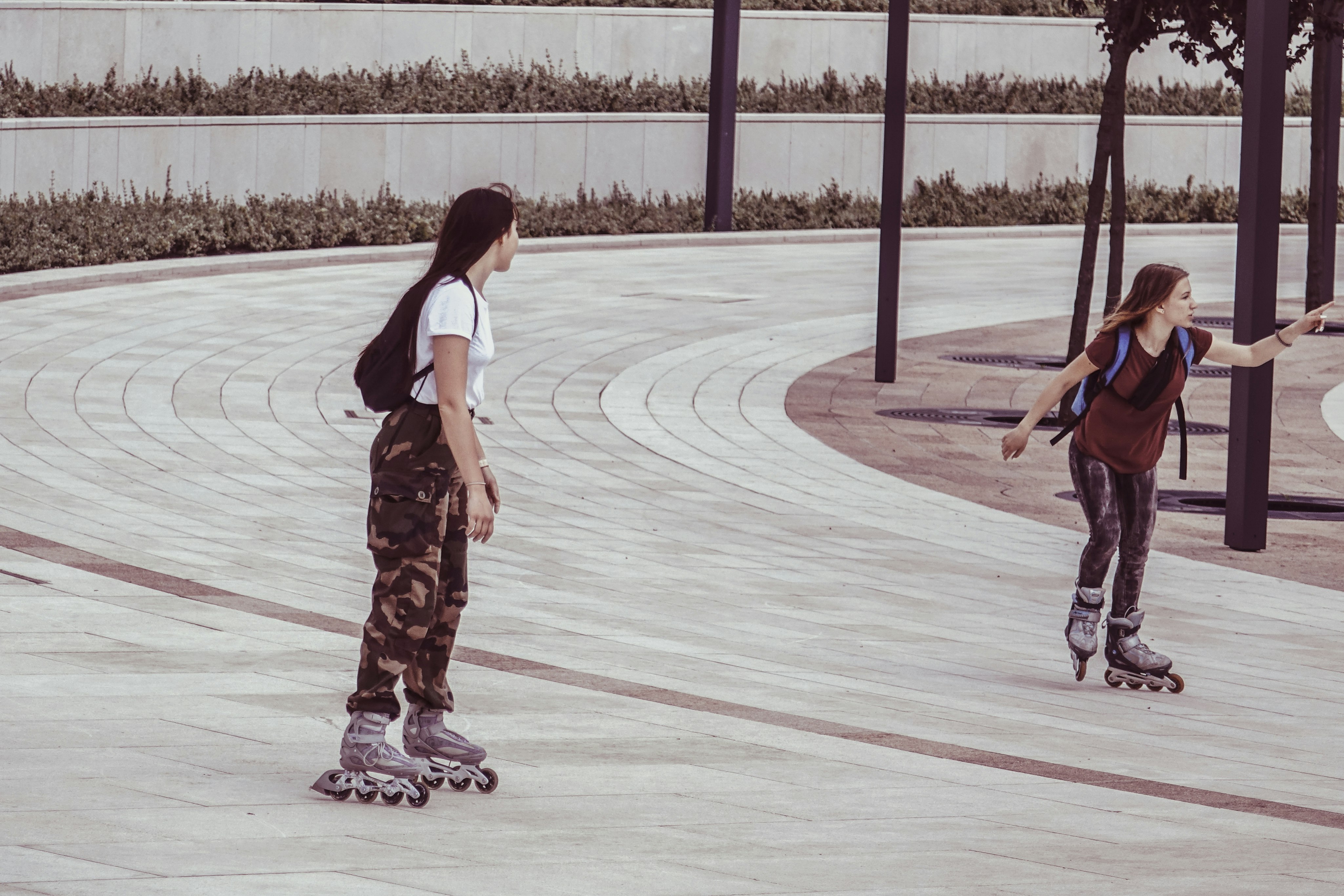 two women inside park while on inline skates