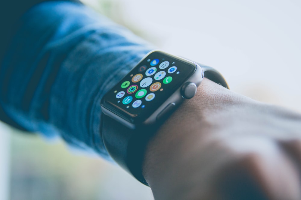 person wearing space gray aluminum case Apple Watch