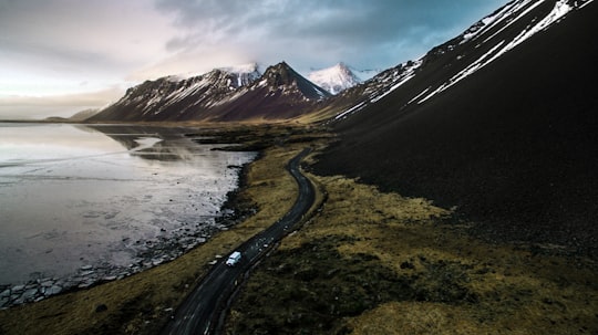 mountains near body of water in Stokksnes Iceland