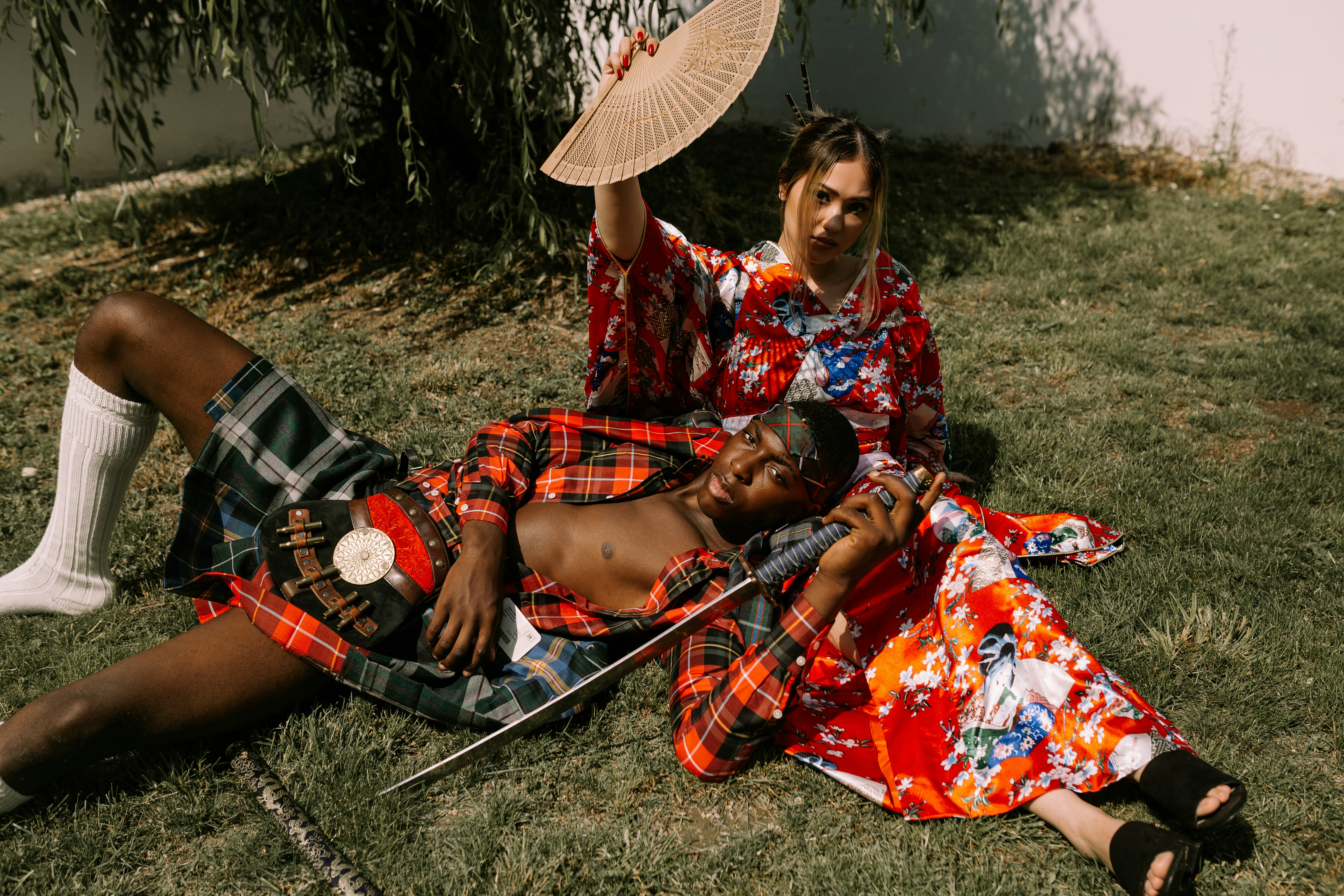 man lying on woman's lap at daytime