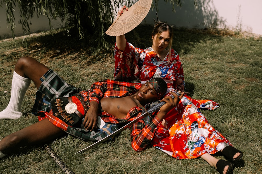 man lying on woman's lap at daytime