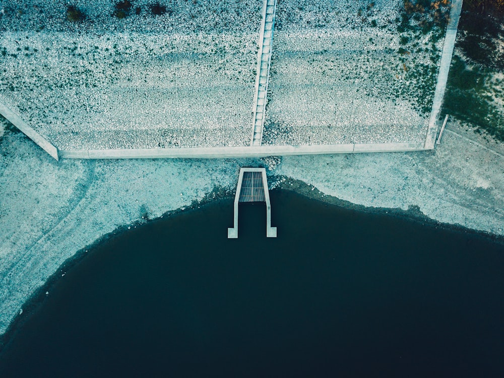 body of water beside a gray stairs