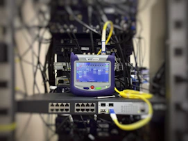 A technician monitoring multiple security screens displaying network activity and alerts.