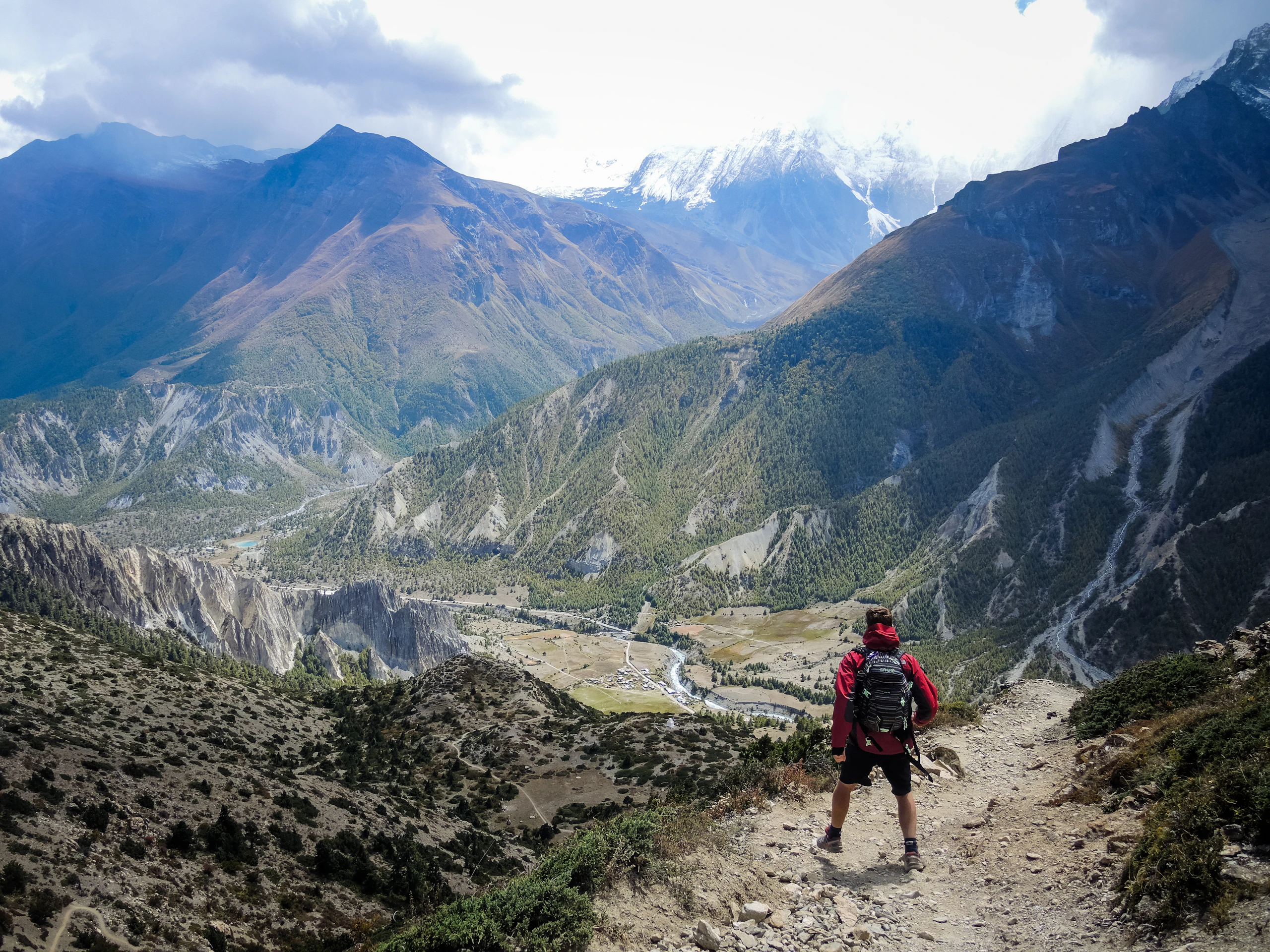 A lone trekker on a quiet winding mountain trail in the Nepal Himalaya