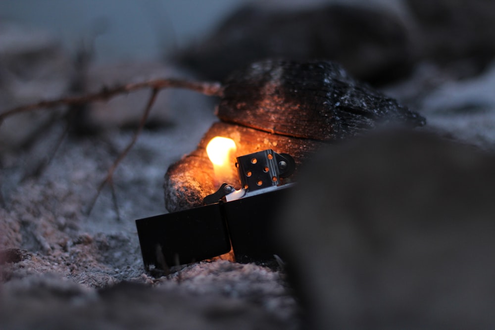closeup photo of lighted black flip lighter