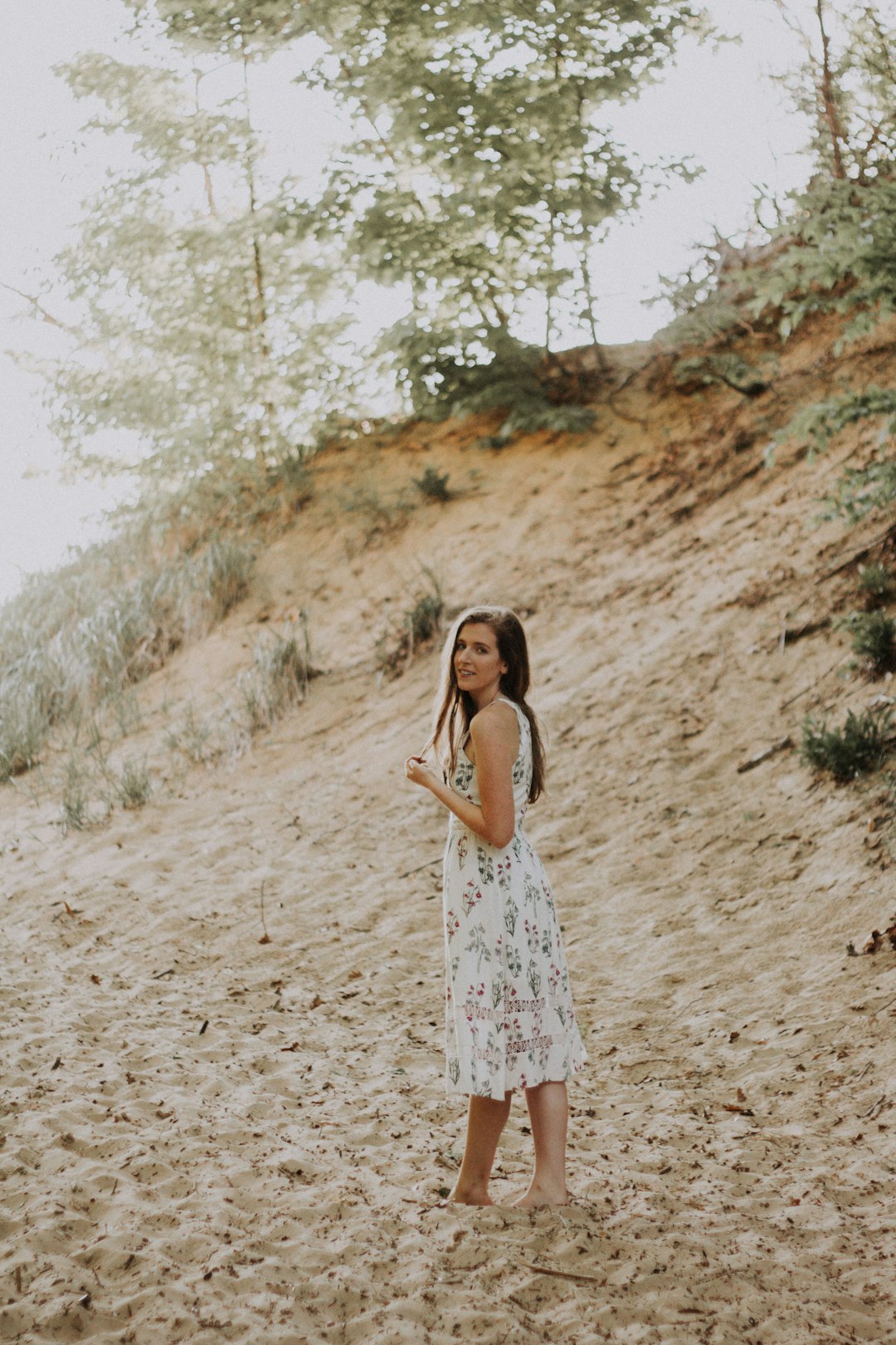 woman on sand wearing dress