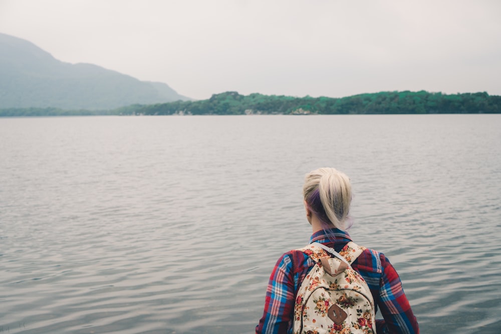 person facing body of water