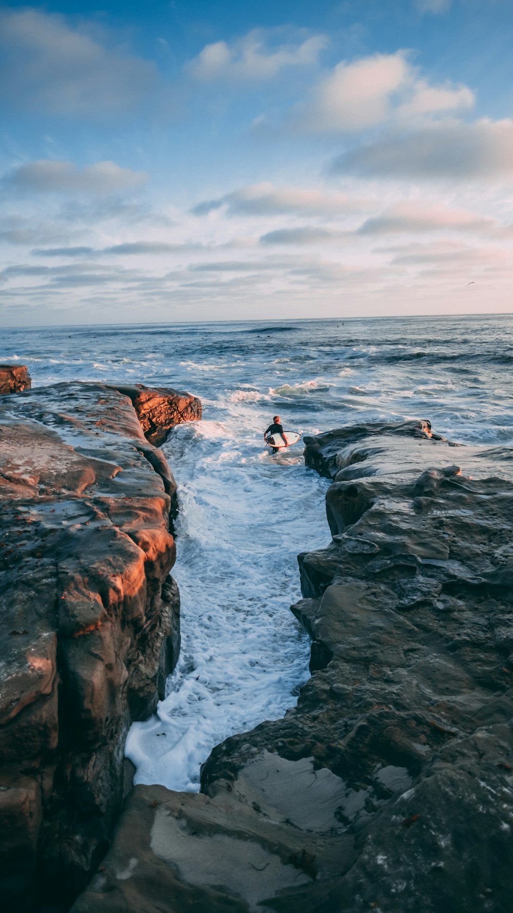 man holding a surfboard in the water