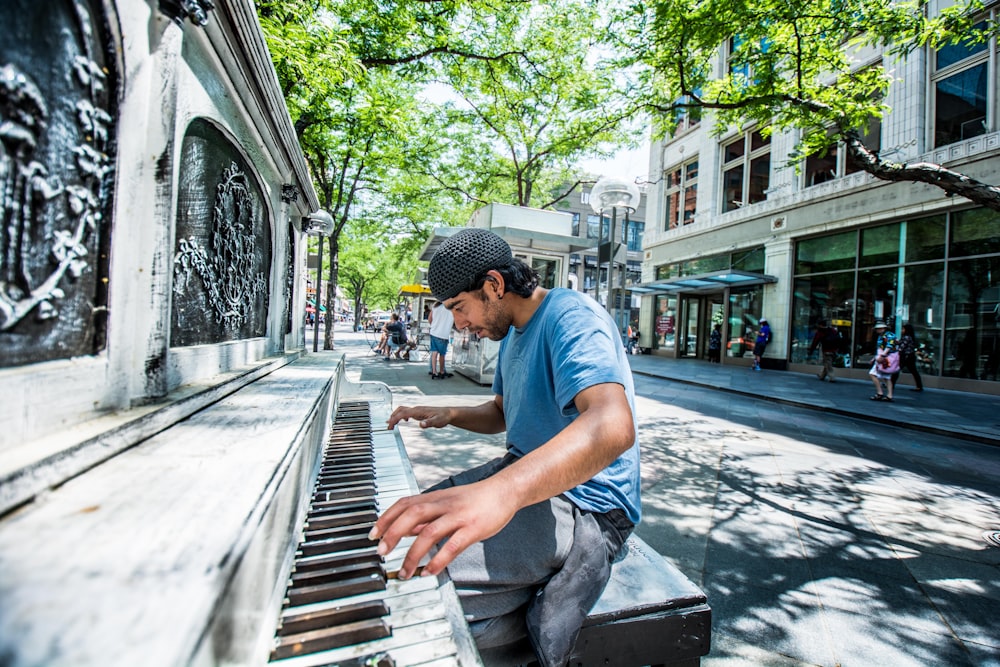 man playing piano on street
