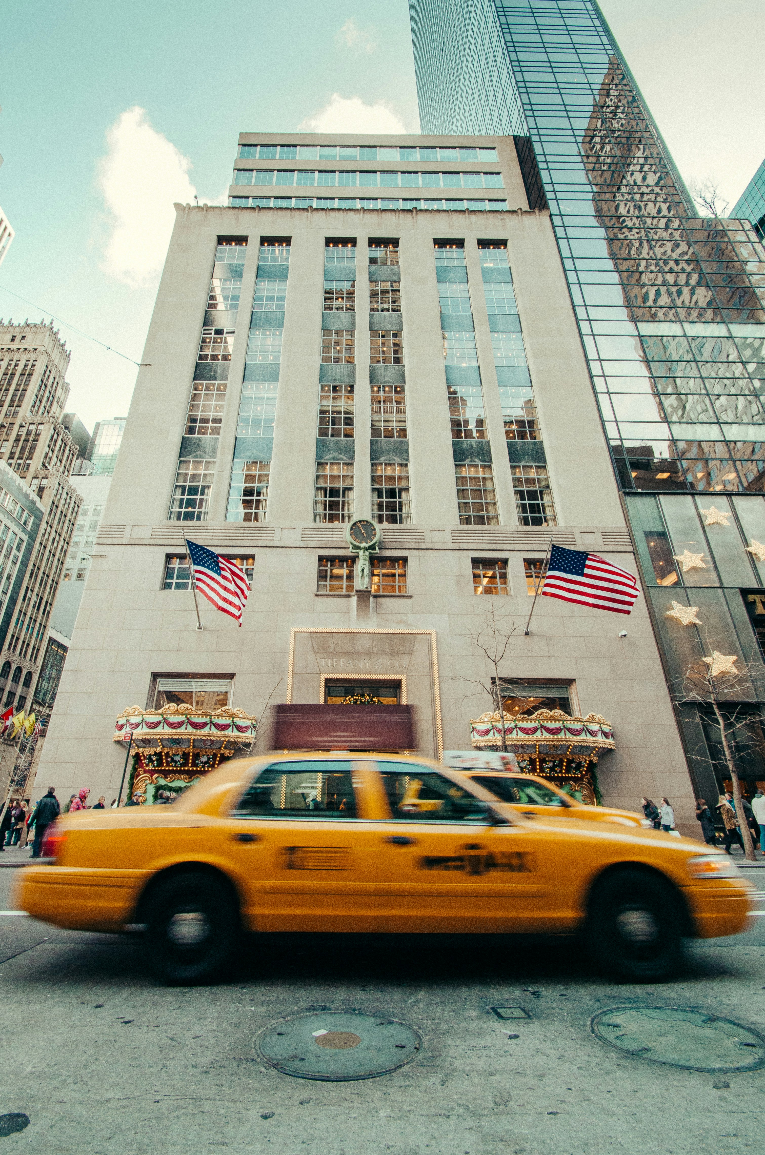 two yellow cabs traveling on gray road