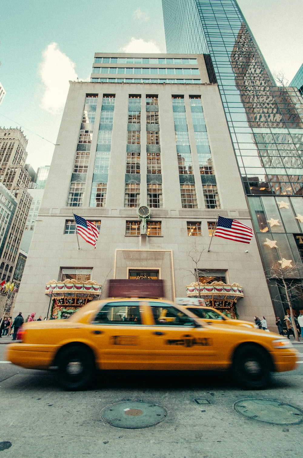 two yellow cabs traveling on gray road