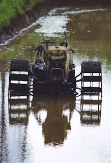 A tractor covered in mud before cleaning in a rural farm setting.