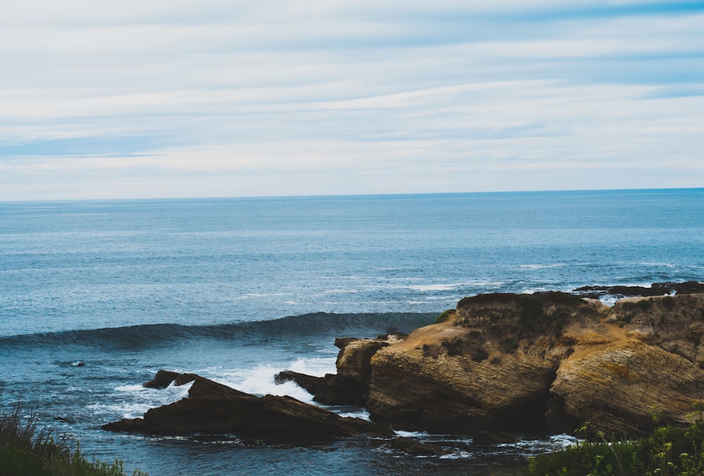 ocean shoreline view under blue sky during daytime