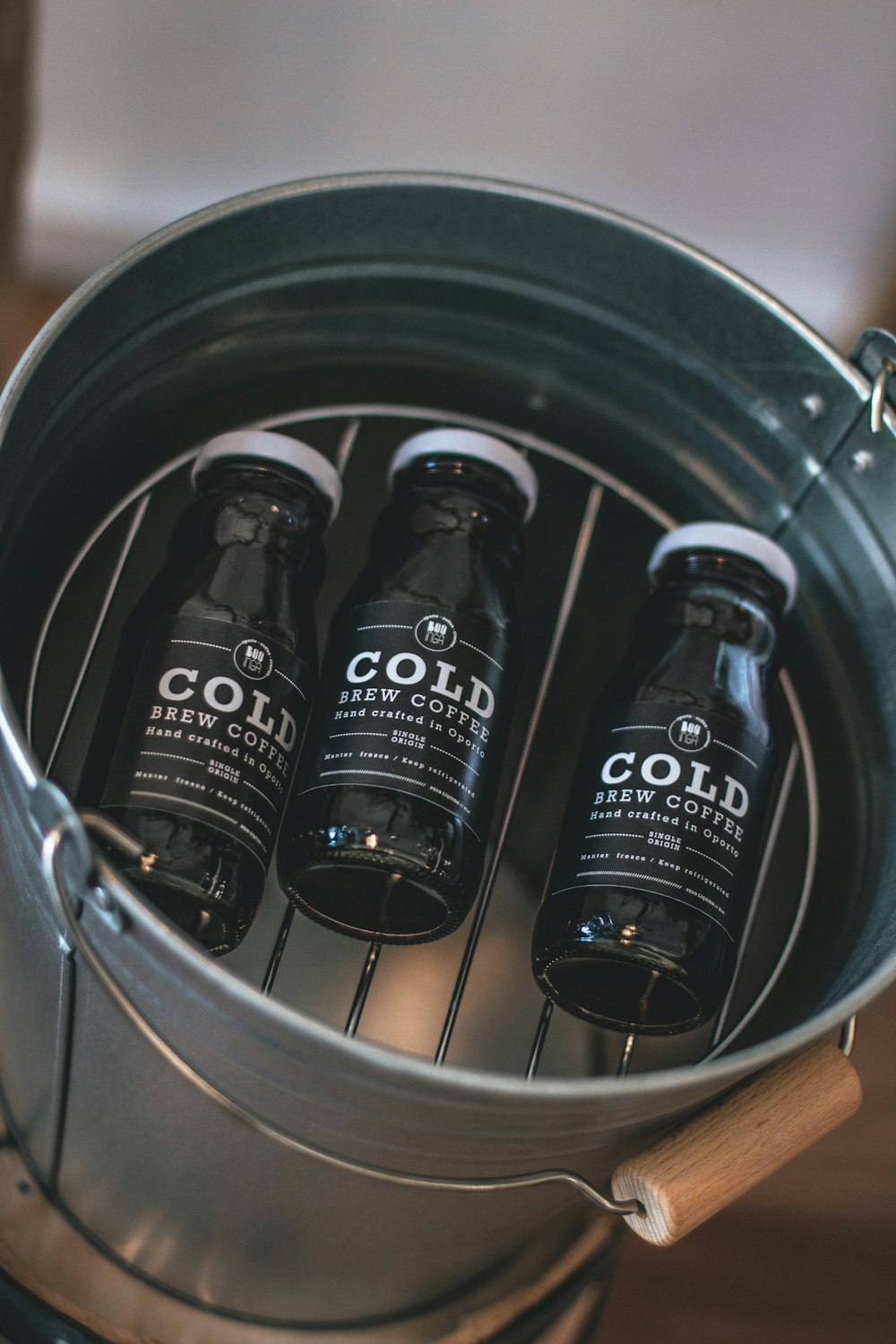 three black glass Cold bottles in bucket