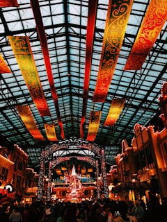 A panoramic view of a bustling event space decorated with banners and lights.