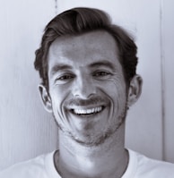 grayscale photography of man smiling