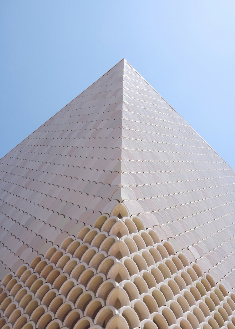 low-angle photography of beige building