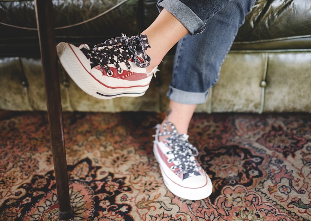 woman in red-and-white sneakers and blue jeans