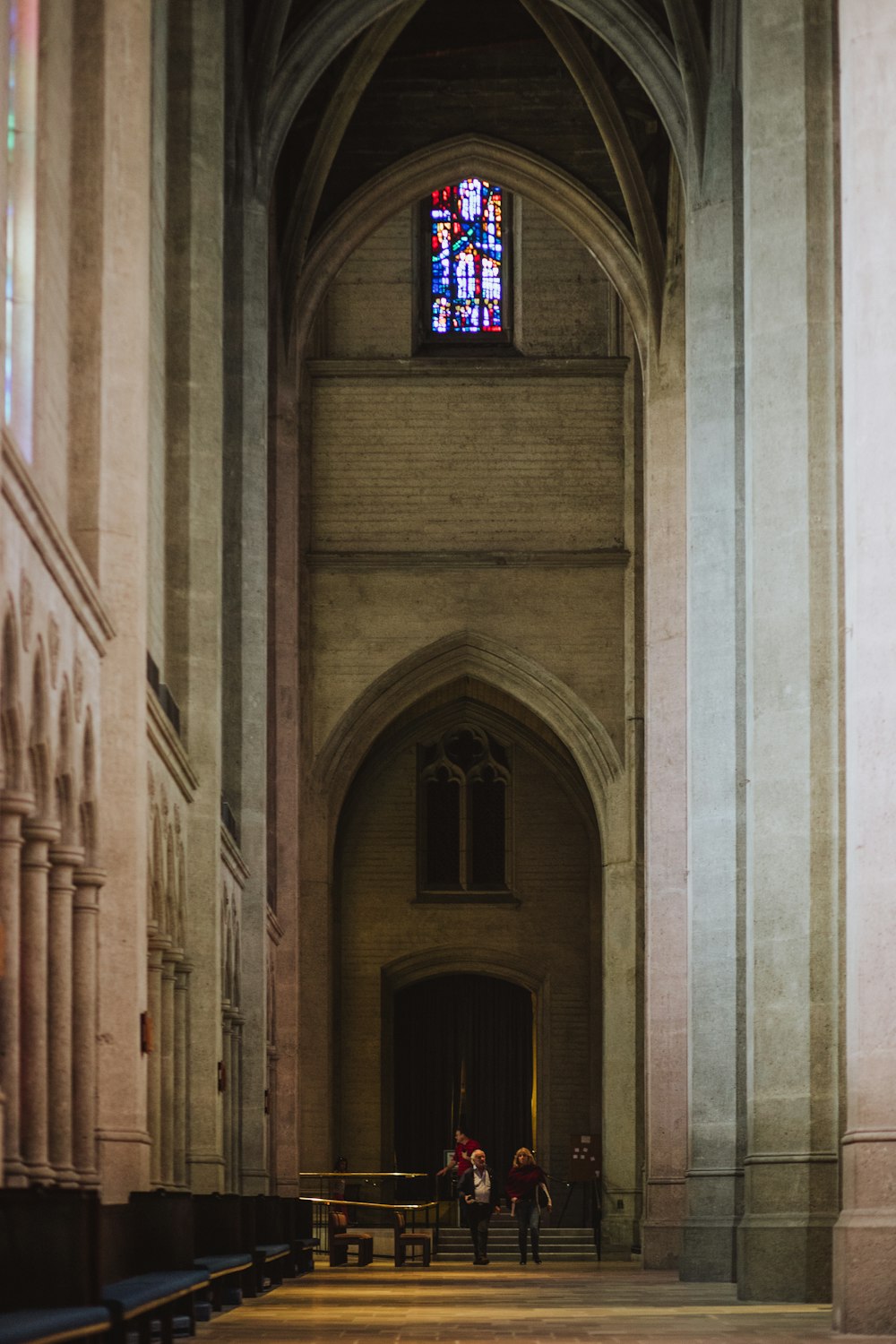 two woman standing on hallway in cathedral