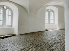 Warm terracotta-hued architectural sketch softly lit by natural daylight.