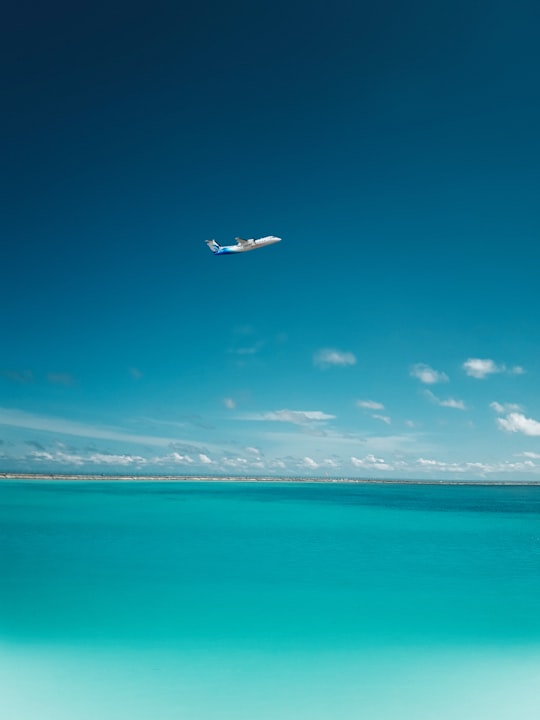 photo of airplane over body of water in Gan International Airport Maldives