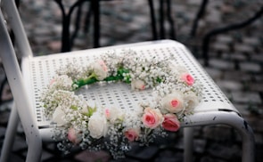 Close-up of delicate DIY floral crown in progress with ribbons and small blossoms