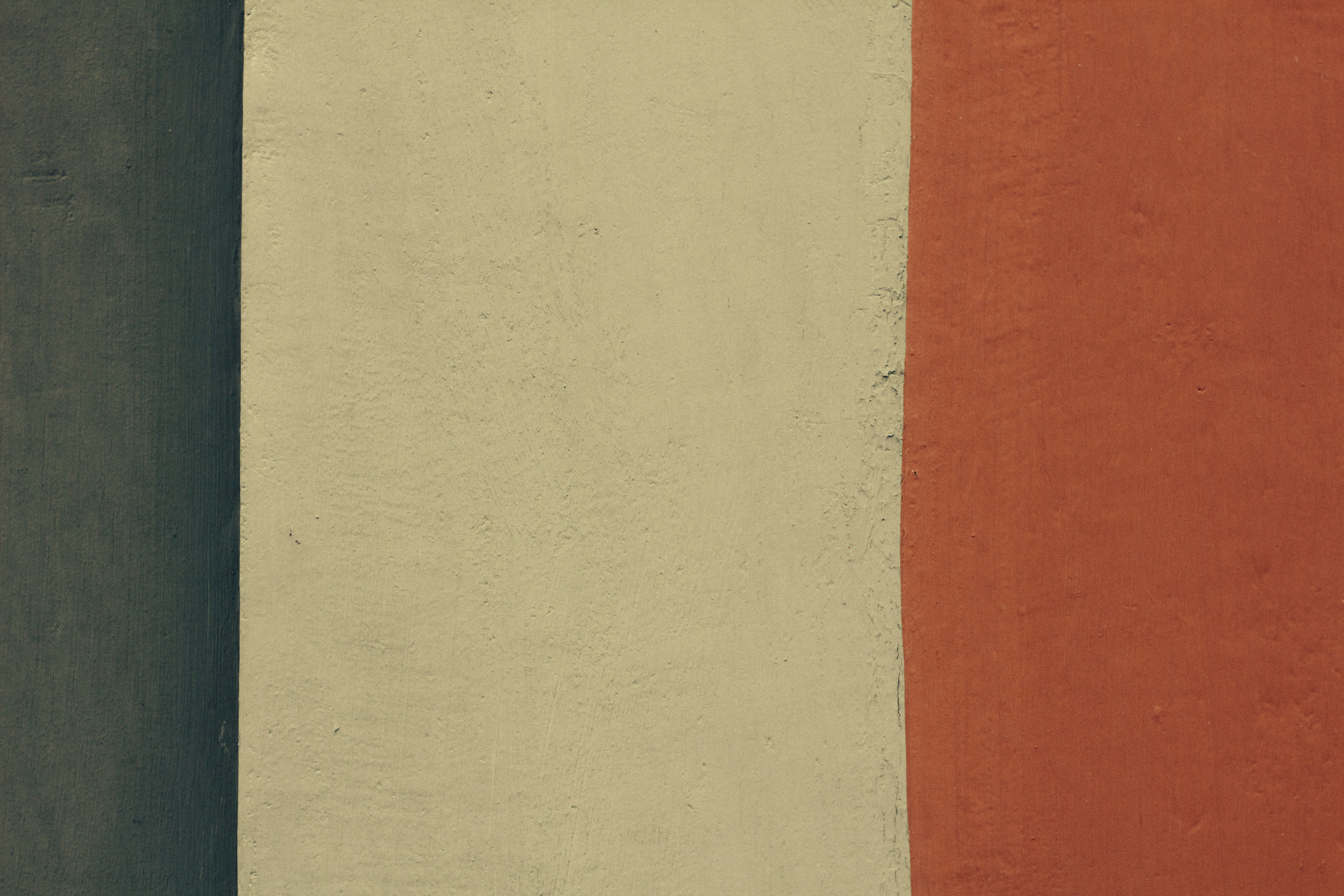 a red, white, and black wall with a clock on it