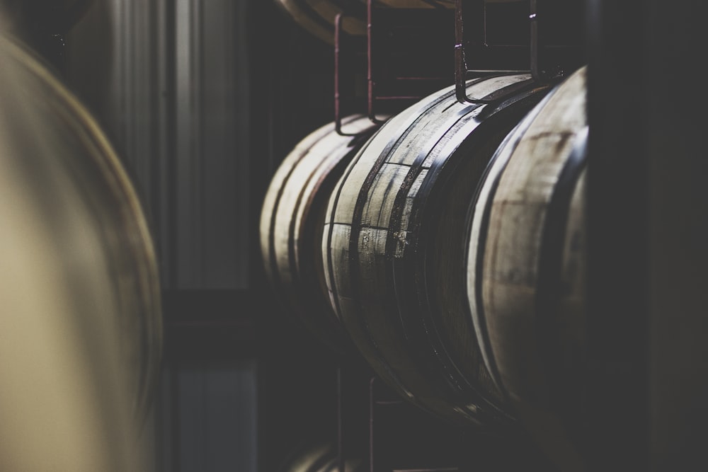 a bunch of wine barrels hanging from a rack