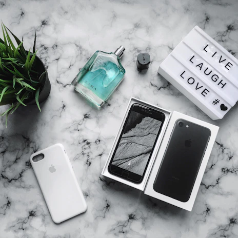 A dynamic flat lay of Zill Mar’s latest collection surrounded by trendy accessories and a smartphone showing social media buzz.