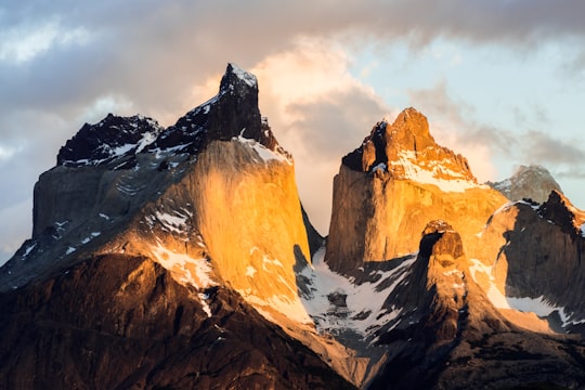 mountain covered with snow under cloudy sky in Torres del Paine National Park Chile