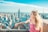 woman on top of tower and overlooking Empire State Building