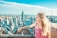 woman on top of tower and overlooking Empire State Building