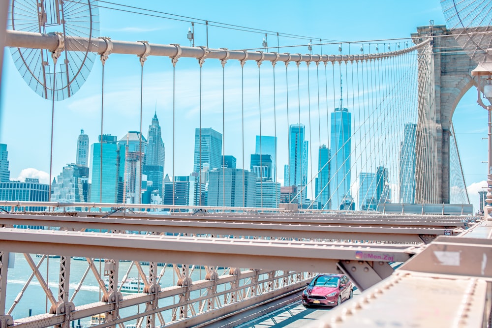 photo of vehicle passing through suspension bridge