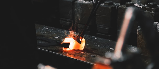 person holding forging tong