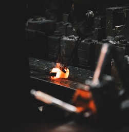 person holding forging tong