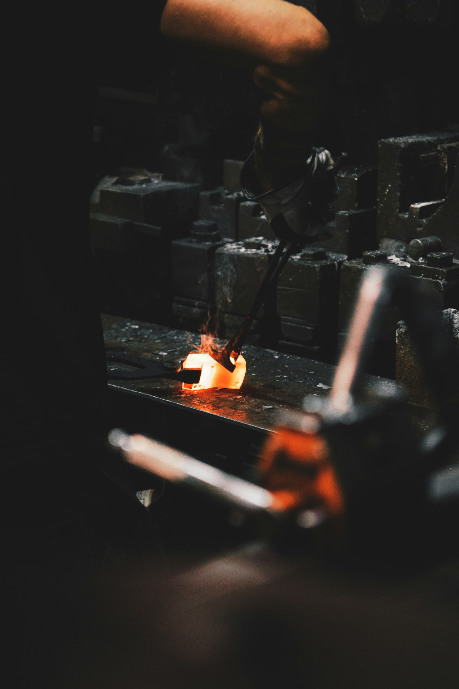 Tongs holding glowing steel at quenching heat