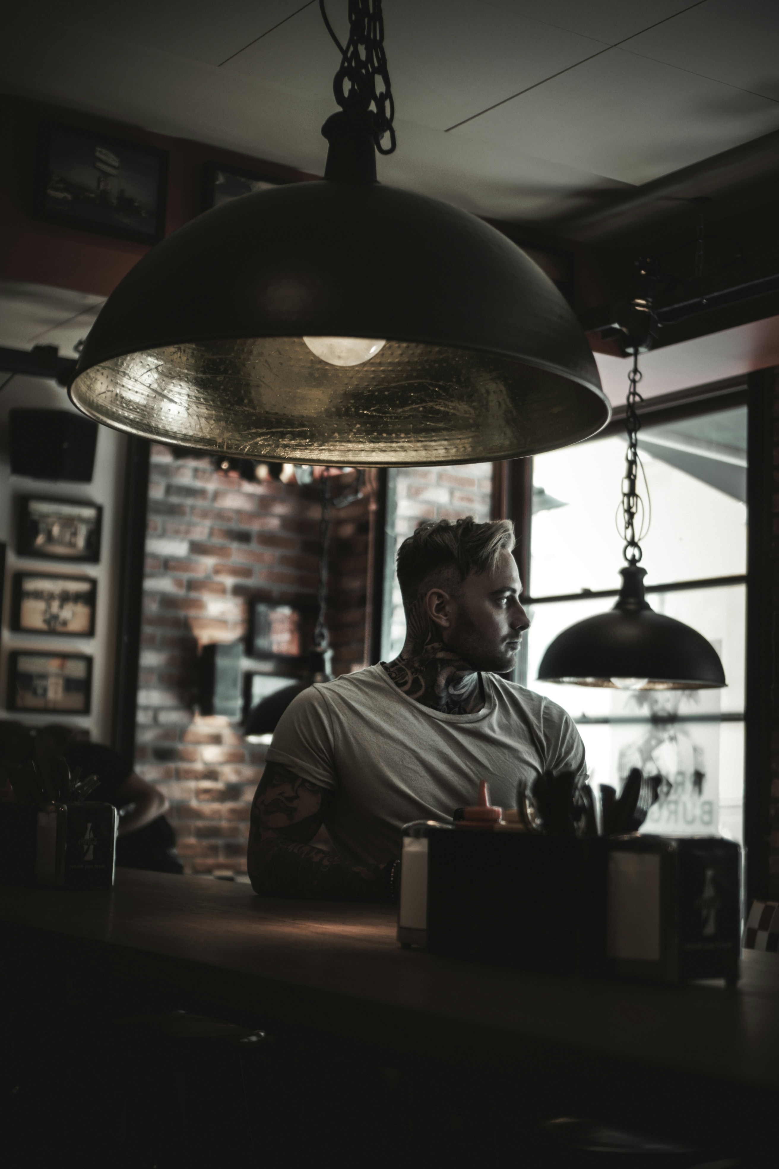 man sitting near pendant lamp
